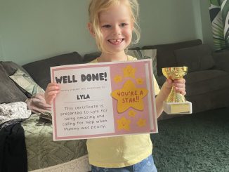 Lyla Leathem with a trophy and certificate for helping her mother. LEAH BIGGS VIA SWNS.