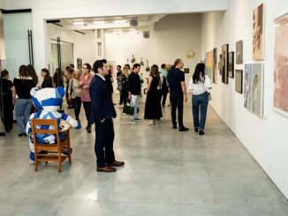 Visitors observe the artworks at the inaugural Art Up Nation exhibition. Photo courtesy of Art Up Nation
