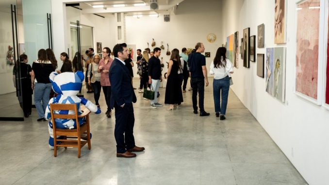 Visitors observe the artworks at the inaugural Art Up Nation exhibition. Photo courtesy of Art Up Nation